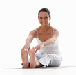 Fit young woman stretching isolated on white