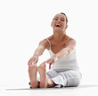 Fit young woman stretching isolated on white , laughing