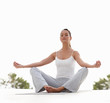 Toned young female meditating outside , lotus position