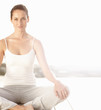 Cute young woman practicing yoga outdoors