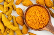 Spoon of Turmeric powder with turmeric barks