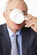 Elderly business man sipping coffee from the cup