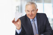 Happy mature business man throwing a paper plane