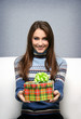 Pretty smiling girl gives a gift in packing Pretty smiling girl gives a gift in packing