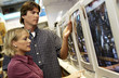 Photo: Couple looking at televisions Couple looking at televisions