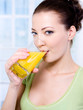caucasian woman with a glass of orange juice