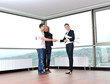 happy young couple buying new home with real estate agent