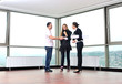 happy young couple buying new home with real estate agent