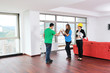 happy young couple buying new home with real estate agent