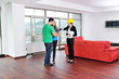 happy young couple buying new home with real estate agent
