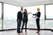 happy young couple buying new home with real estate agent