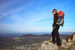 female Hiker is looking over the city