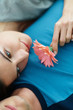 Photo: Closeup of a young female with a flower on boyfriend's chest Closeup of a young female with a flower on boyfriend's chest