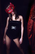 Young girl in red mask and black dress
