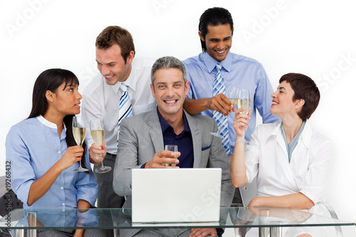 Photo: Cheerful business team toasting with Champagne Cheerful business team toasting with Champagne