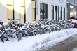 Photo: A row of snowcovered bikes A row of snowcovered bikes