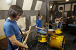 rock band. two guitarists and drummer working in studio