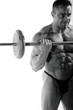 Bodybuilder exercising in front of white background
