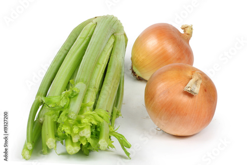 Photo: two onions and a single celery close-up white background two onions and a single celery close-up white background