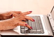 Female hands on Laptop Keyboard