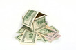 House made from hundred dollar bills on white background House made from hundred dollar bills on white background