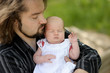 Little newborn baby in father's hands