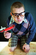 Funny nerd with a toy airplane