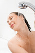 Photo: Young smiling woman taking a shower Young smiling woman taking a shower