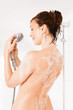 Photo: Young smiling woman taking a shower Young smiling woman taking a shower