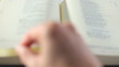 Bible Book scrolling by hand