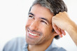 Closeup of a happy man resting his head on hand