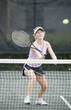 Mature woman hitting a tennis ball