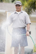 Senior man watering flowers