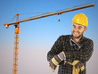 manual worker with crane background and blue sky
