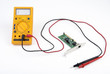 Photo: Multimeter and circuit board Multimeter and circuit board