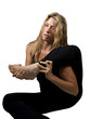 Flexible blond woman stretches with leg above shoulder