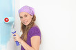 Photo: woman painting wall with roller in home woman painting wall with roller in home