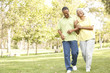 Photo: Senior Couple Walking In Park Senior Couple Walking In Park