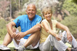 Senior Couple Resting After Exercising In Park Senior Couple Resting After Exercising In Park