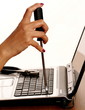 Female hand with tool repairing computer