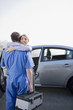 Woman hugging arriving mechanic