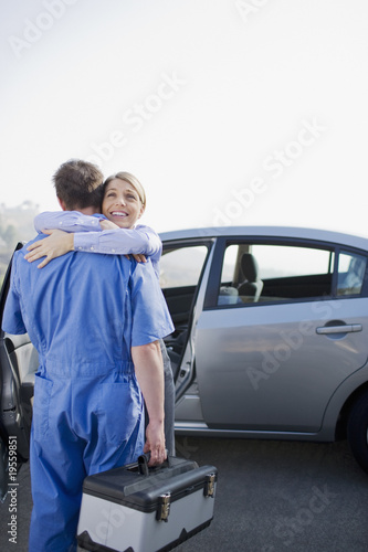 Photo: Woman hugging arriving mechanic Woman hugging arriving mechanic