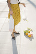Frustrated woman dropping groceries on sidewalk
