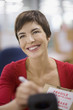 Businesswoman marking fragile box with marker