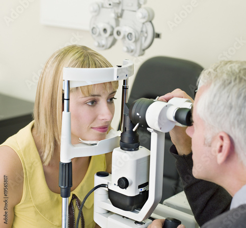 Photo: Ophthalmologist giving patient eye exam Ophthalmologist giving patient eye exam