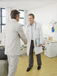 Doctor greeting patient in hospital room