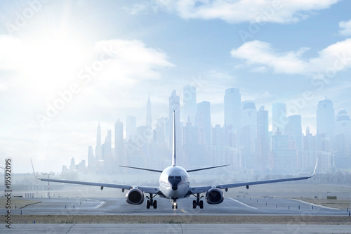 Photo: Big aircraft on runway in big city Big aircraft on runway in big city