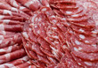 Cutting sausage and cured meat on a celebratory table