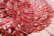 Cutting sausage and cured meat on a celebratory table