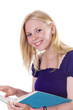 Photo: Blonde girl looking up from study book smiling Blonde girl looking up from study book smiling